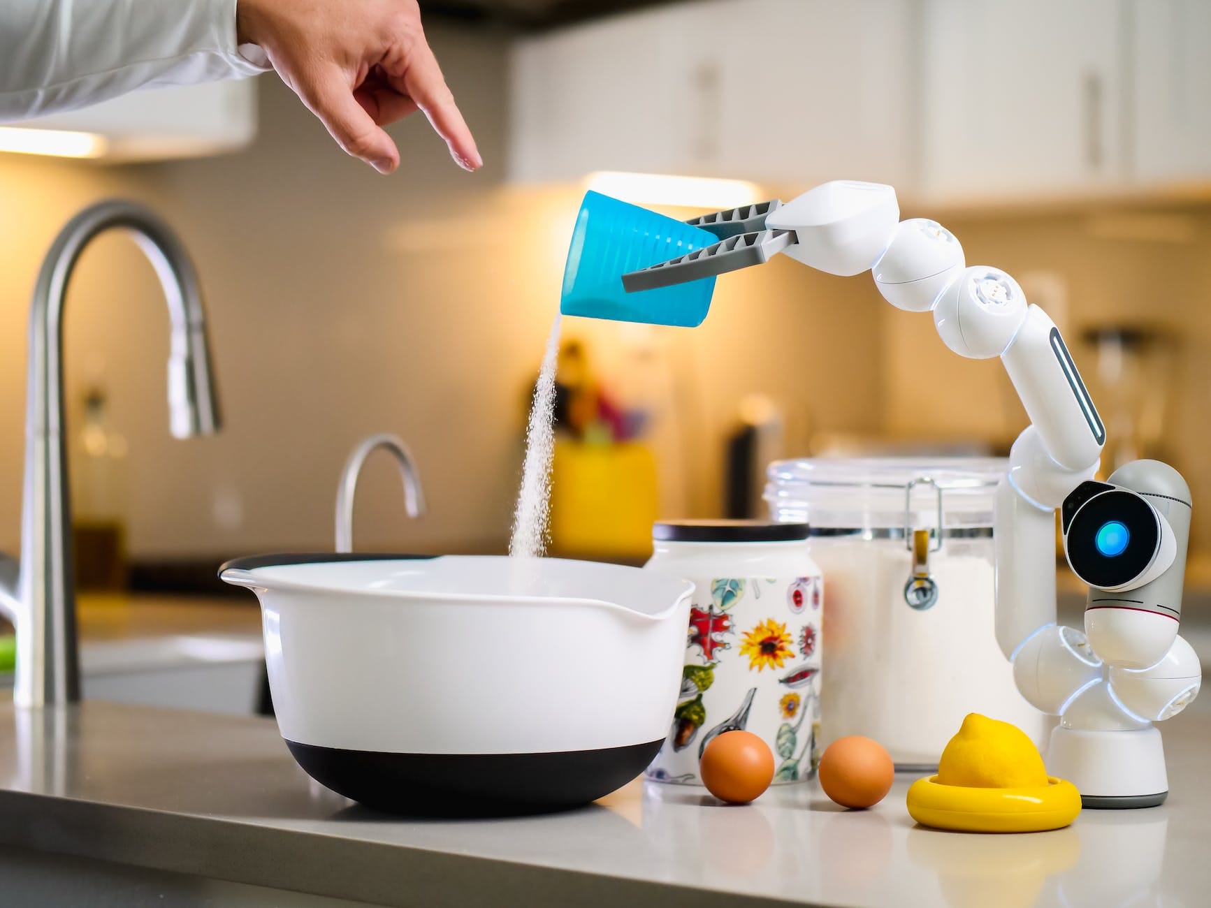 robot hand pouring flour into white bowl