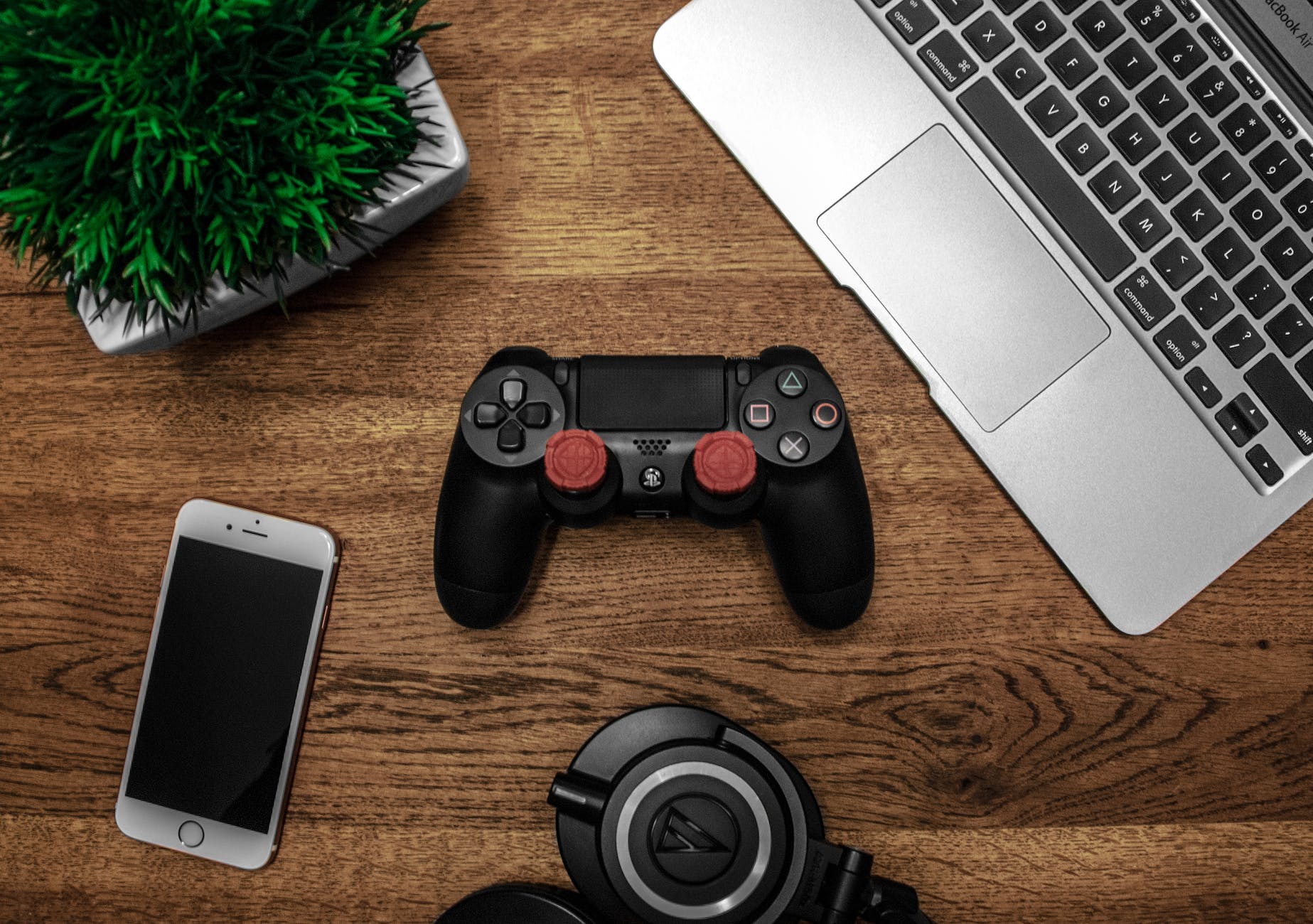black game console on wooden surface