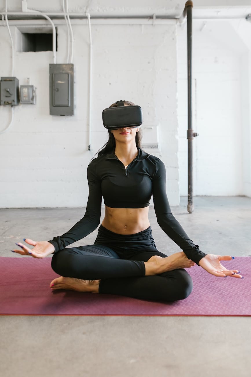 woman doing yoga while wearing virtual reality glasses
